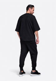 Model showing back of oversized black t-shirt with tassel by East Vibe